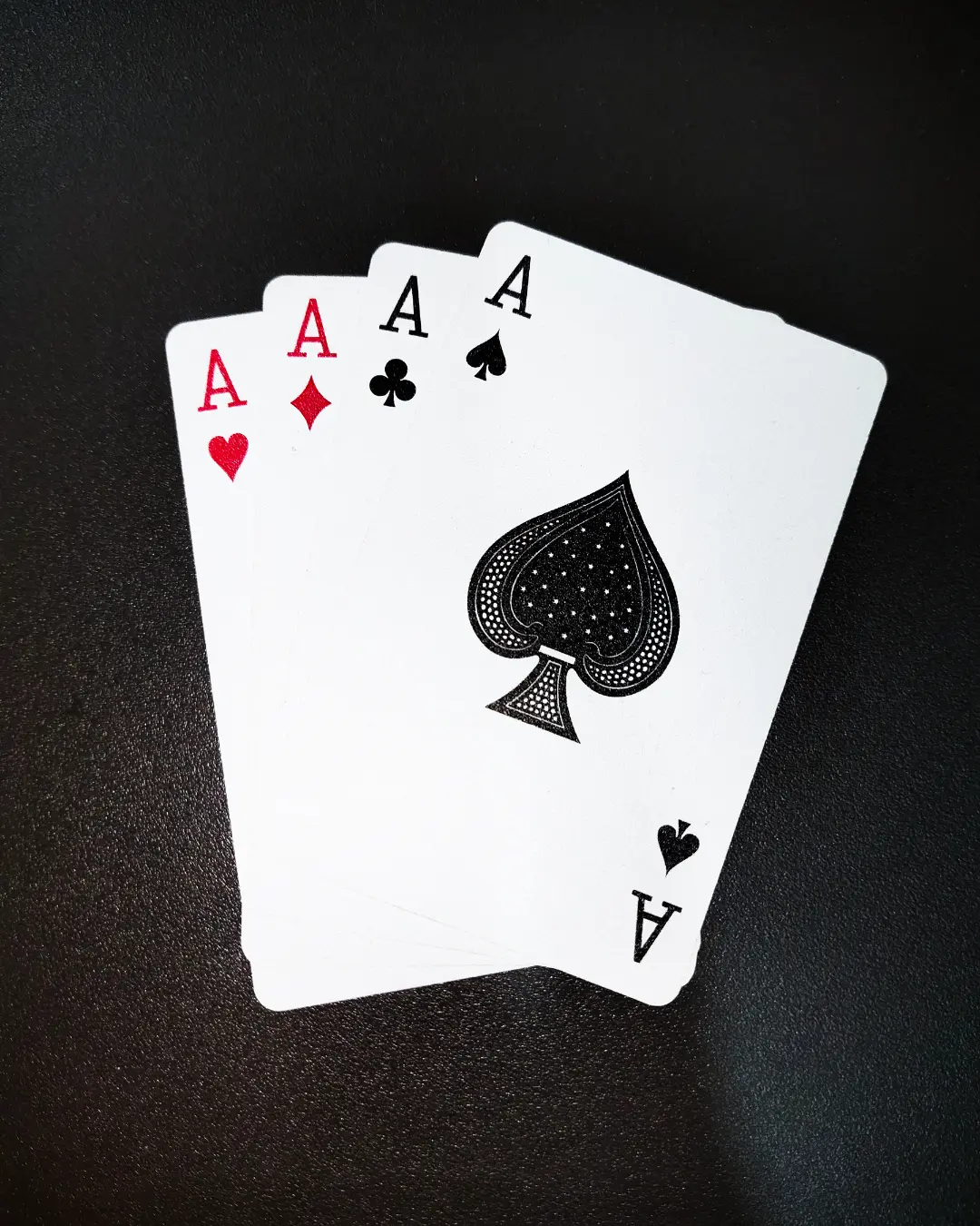 four playing cards with aces symbolizing tennis ace