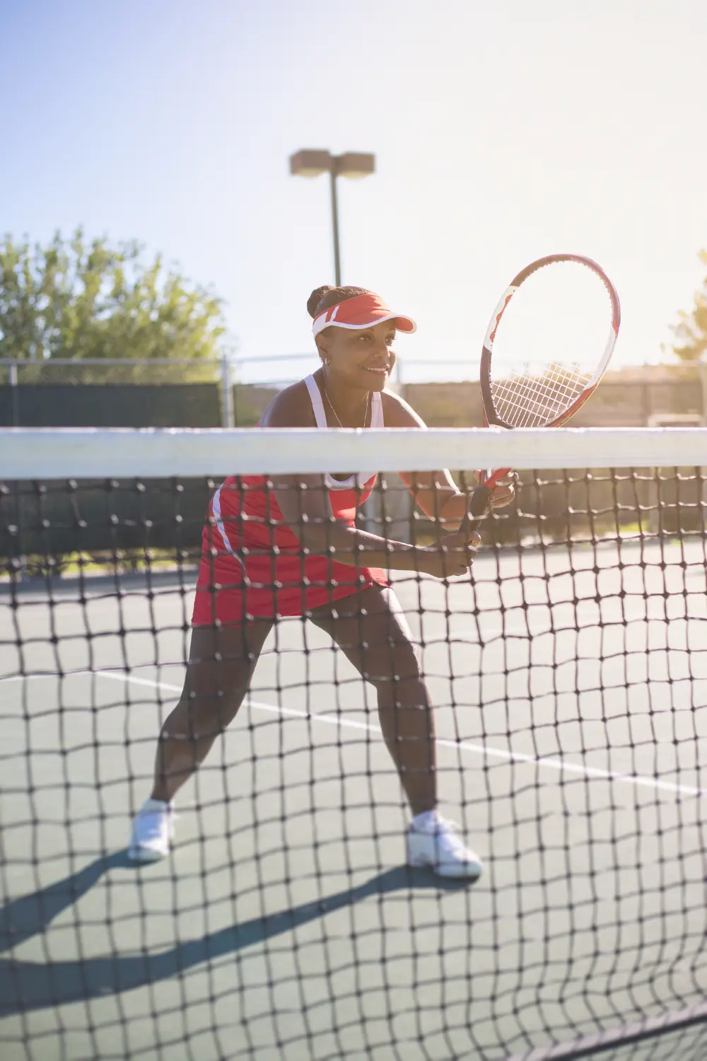 Tennis player training near the net during a practice session