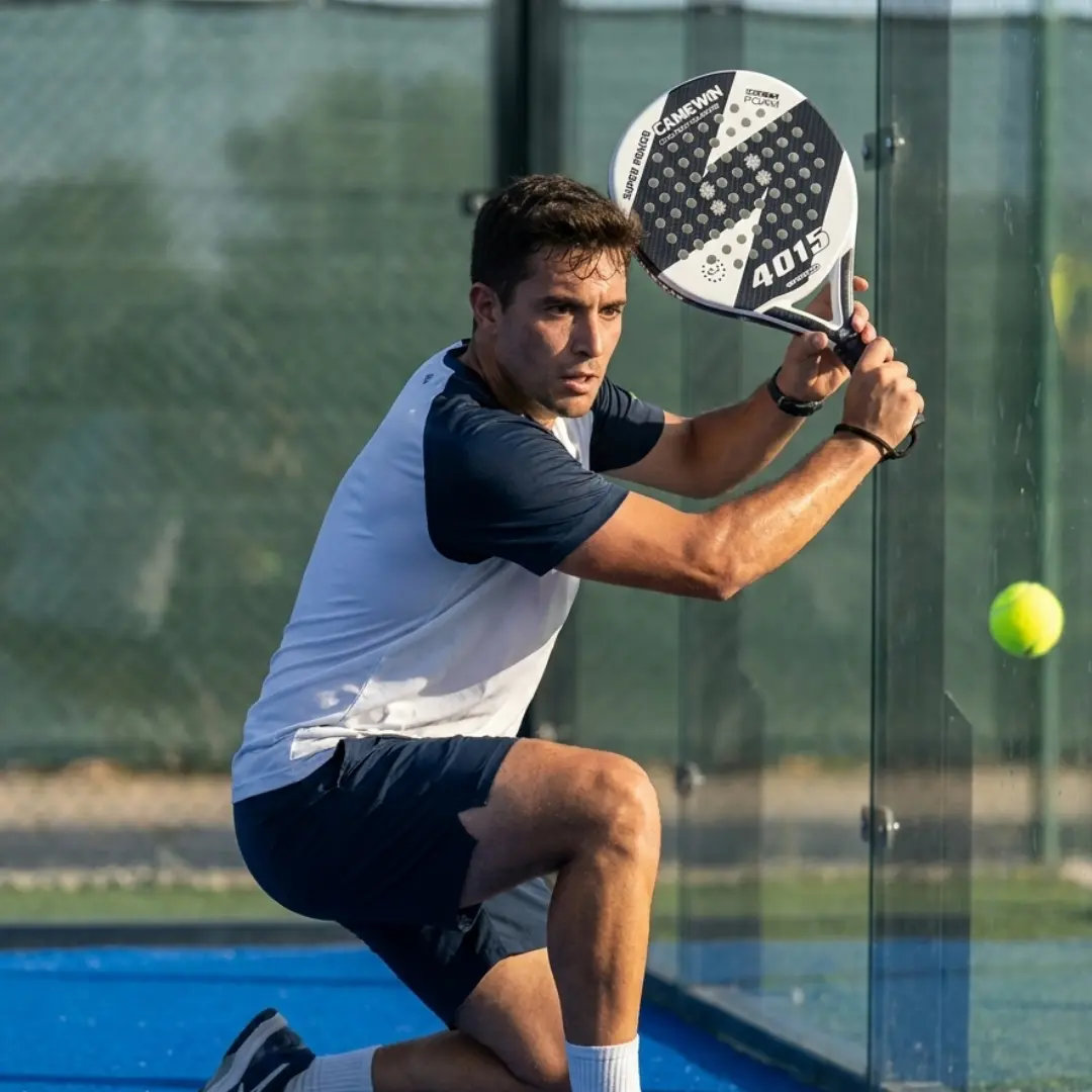 Padel player hitting defensive shot near glass wall showing off-center impact vibrations